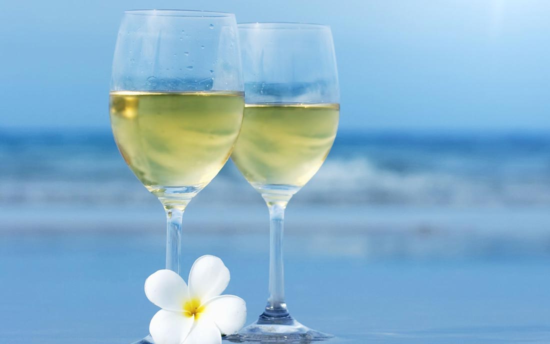 Wine-Glasses-With-White-Flower-Closeup-Near-Sea